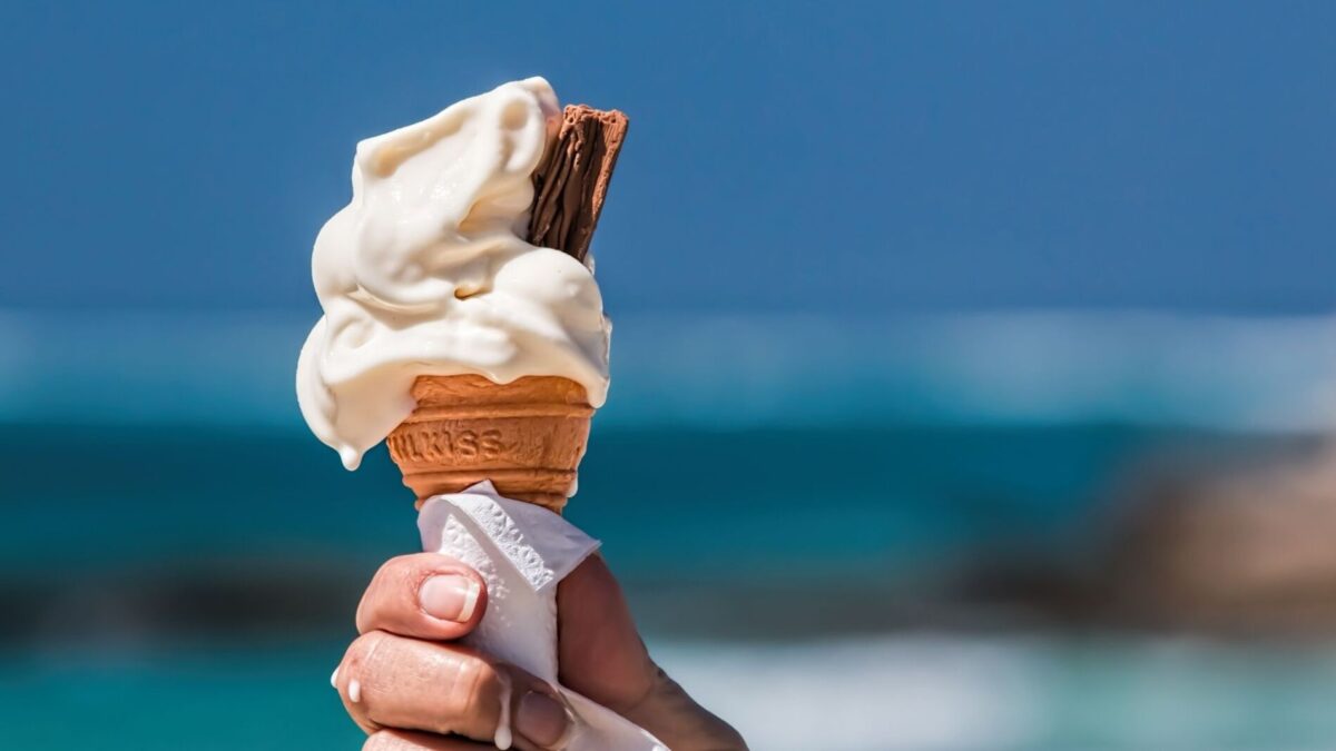 A patron enjoys ice cream on the beach near our anna maria island rentals
