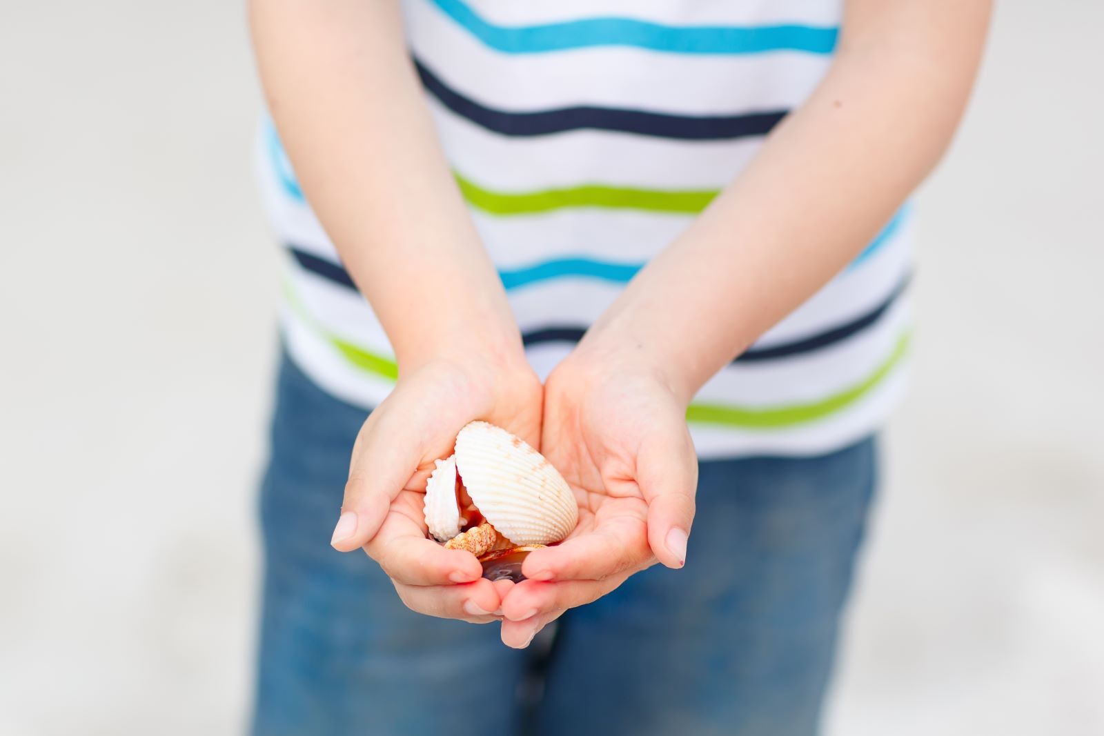 kid holding shells 