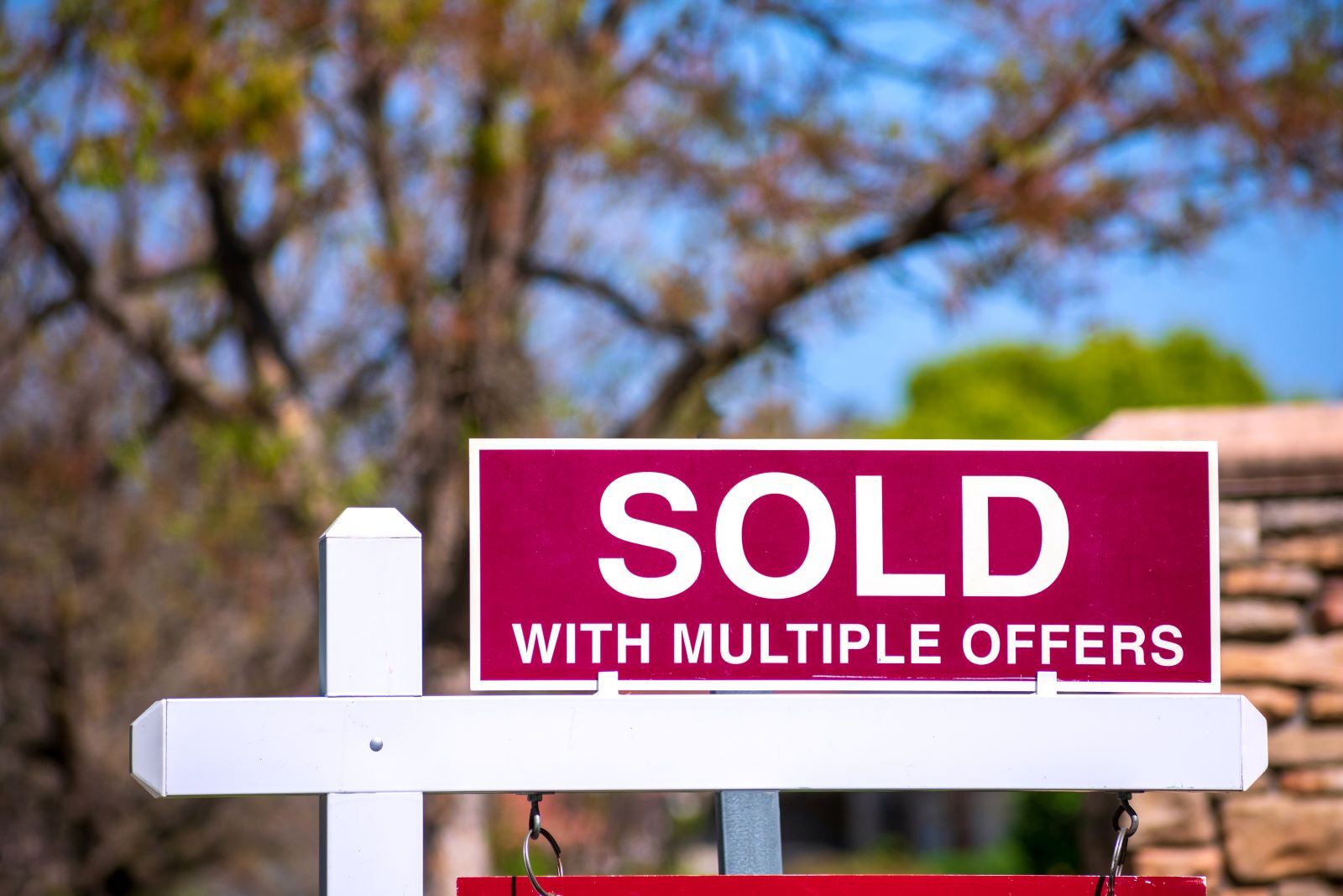 Sign that reads "Sold with multiple offers", located outside of home