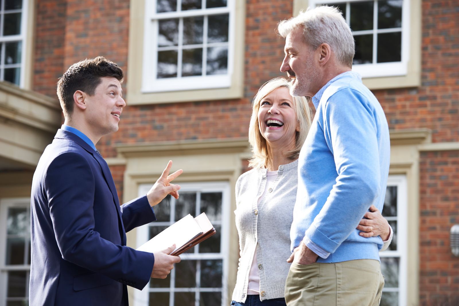 Couple conversing with real estate agent